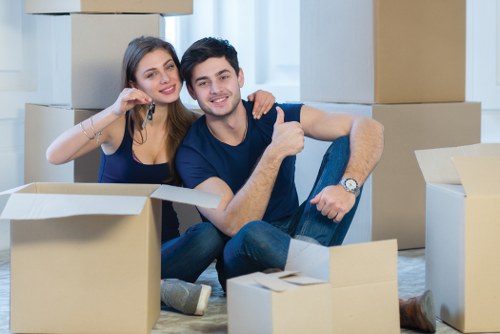 Furniture collection team handling bulky items in a Brent home