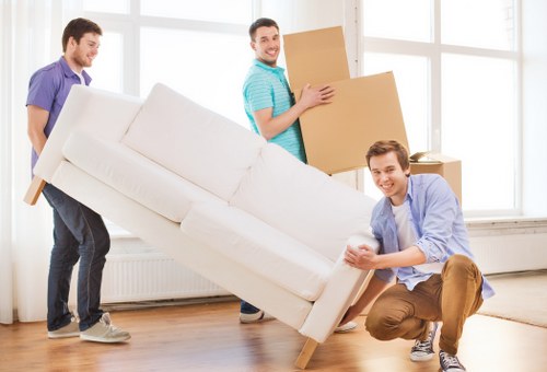 Boxes and furniture being unloaded at a new home in Brent