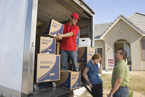 Man and a van moving furniture from a Brent property